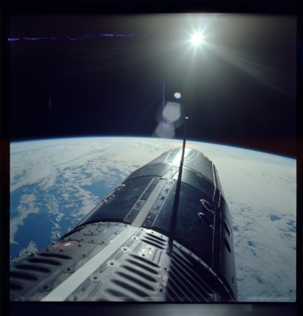 Jun. 5, 1966: S66-38032. Commander (CDR) Eugene A. Cernans Extravehicular Activity (EVA) camera,standing in hatch over Pacific Ocean taken during the Gemini IX mission during orbit no. 31.
